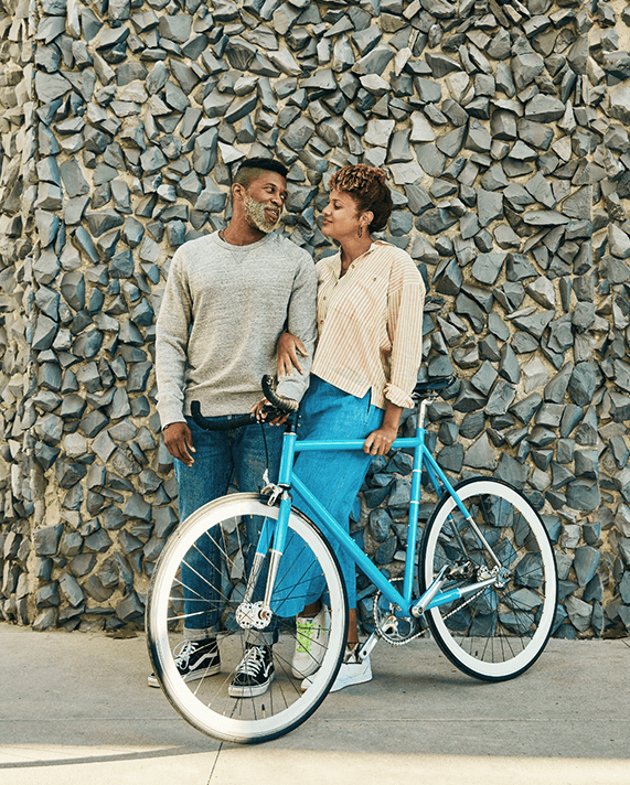couple with bike at wall